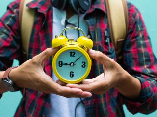 Student holding alarm clock